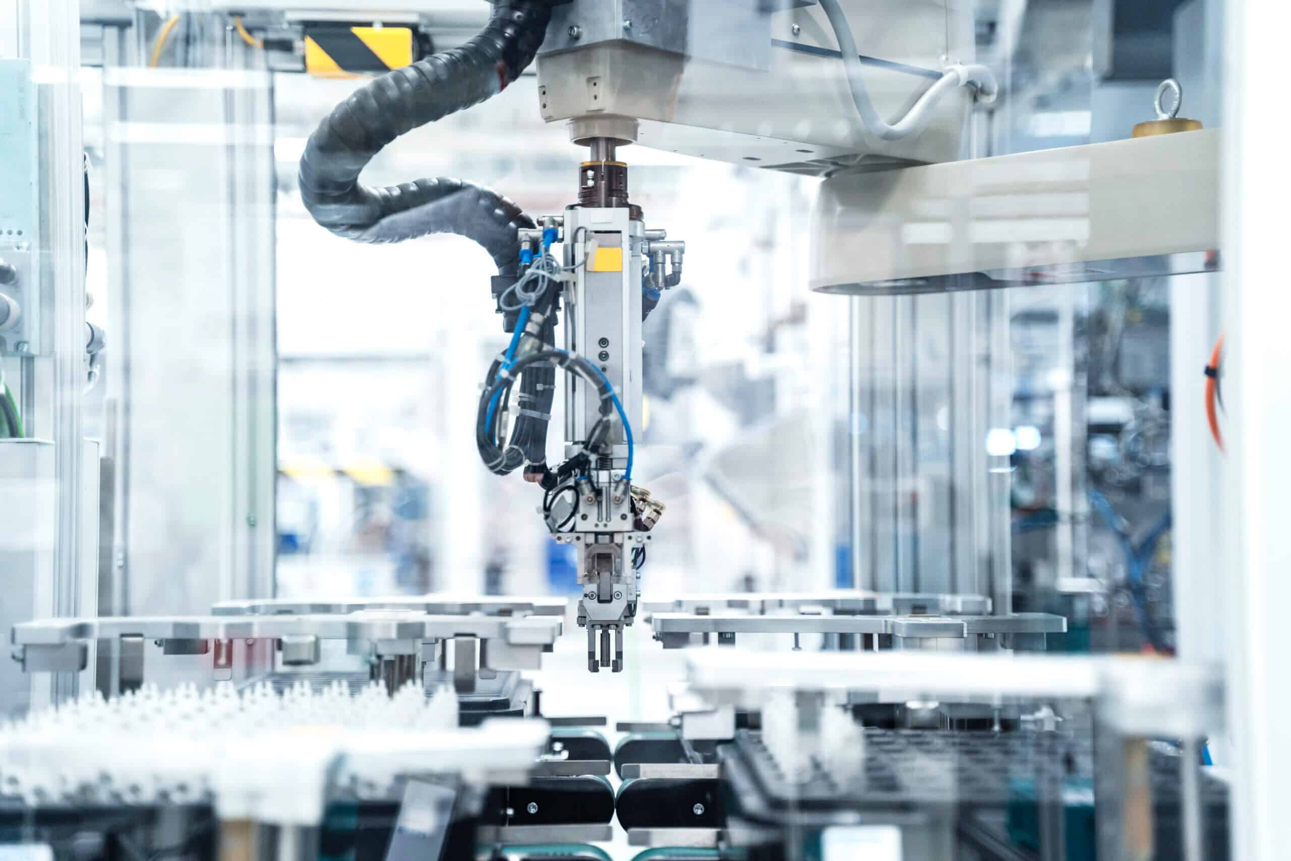 Arm of assembly robot functioning inside modern factory, Stuttgart, Germany