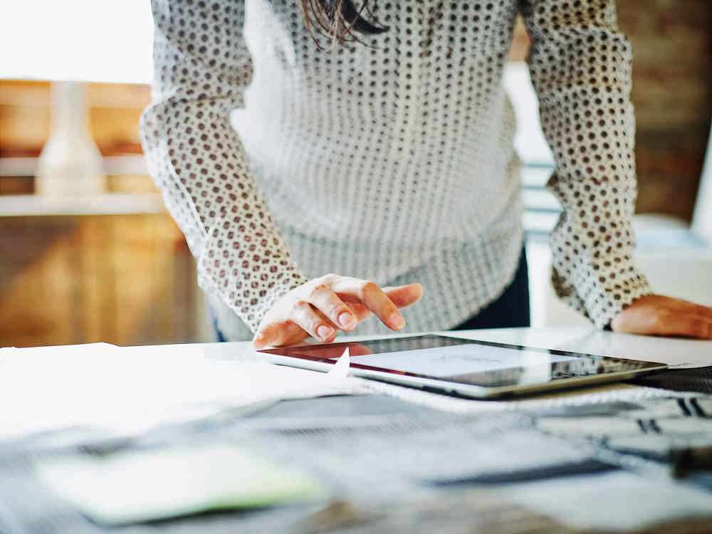 Businesswoman looking at digital tablet in office (2)