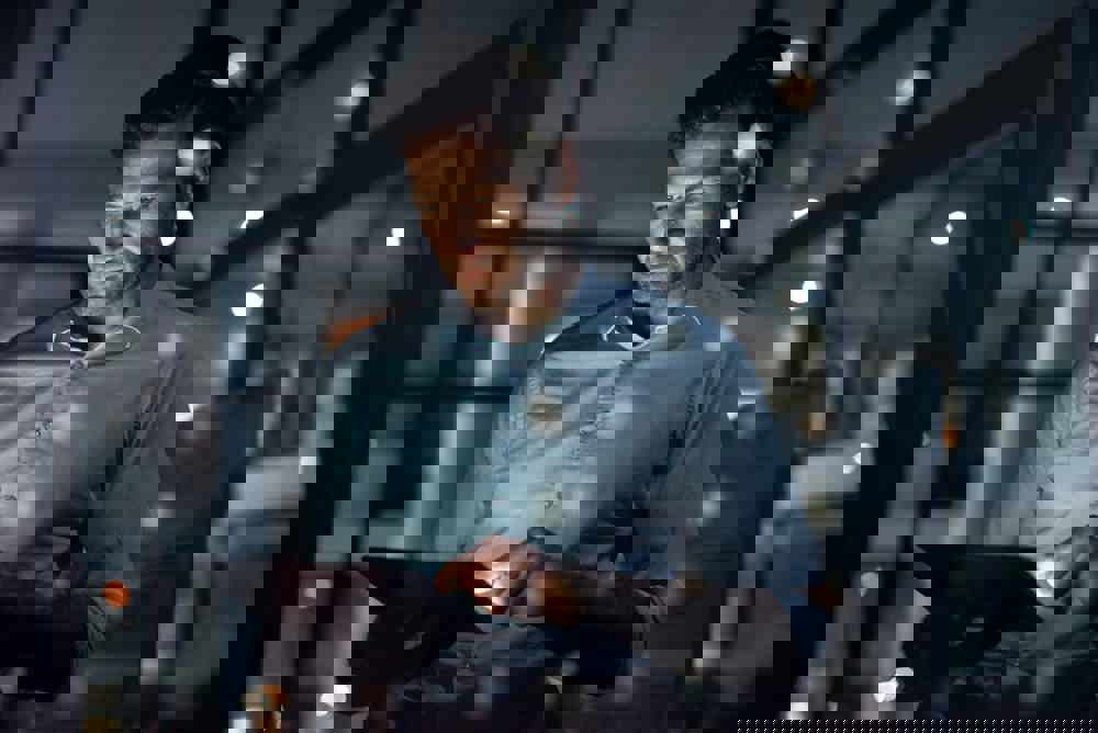 Business man, working and tablet of a employee doing digital, web and internet strategy planning. Corporate businessman and tech worker in the dark using technology to work on online and IT analytics