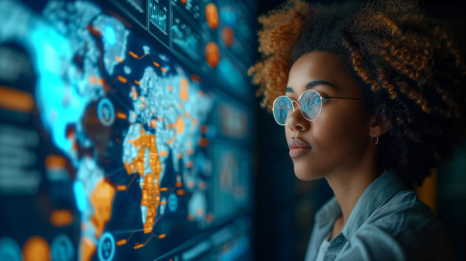 Young female professional analyzing global data analytics on screen (1)