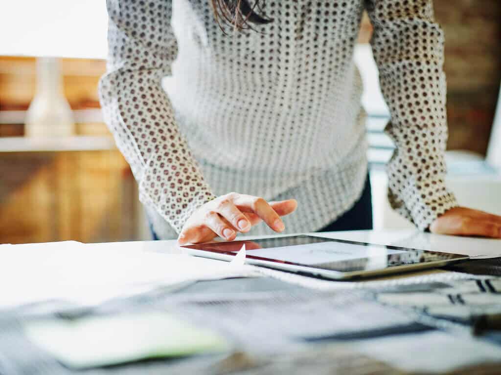Businesswoman looking at digital tablet in office Planning