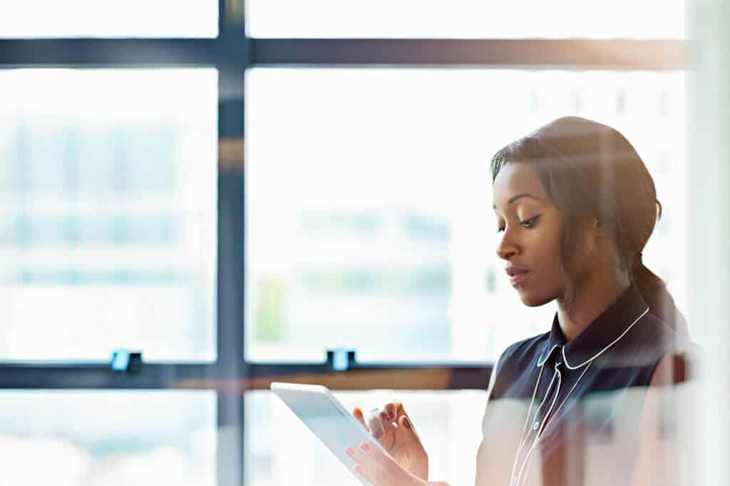 Businesswoman using a digital tablet in office Challenges obtaining trustworthy channel data and using it effectively