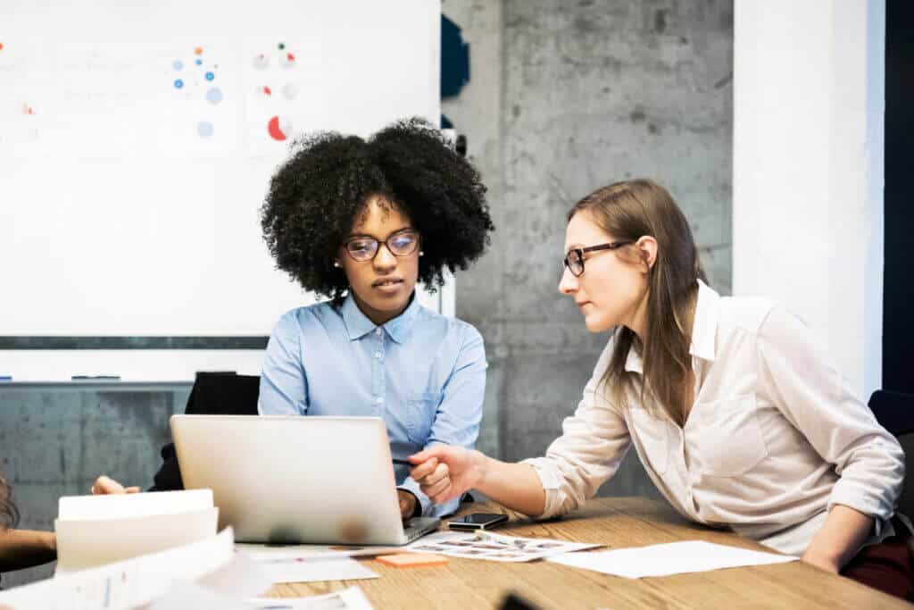 Pay your partners the correct amount with more efficiency and simplicity than ever. Two professionals looking at a laptop