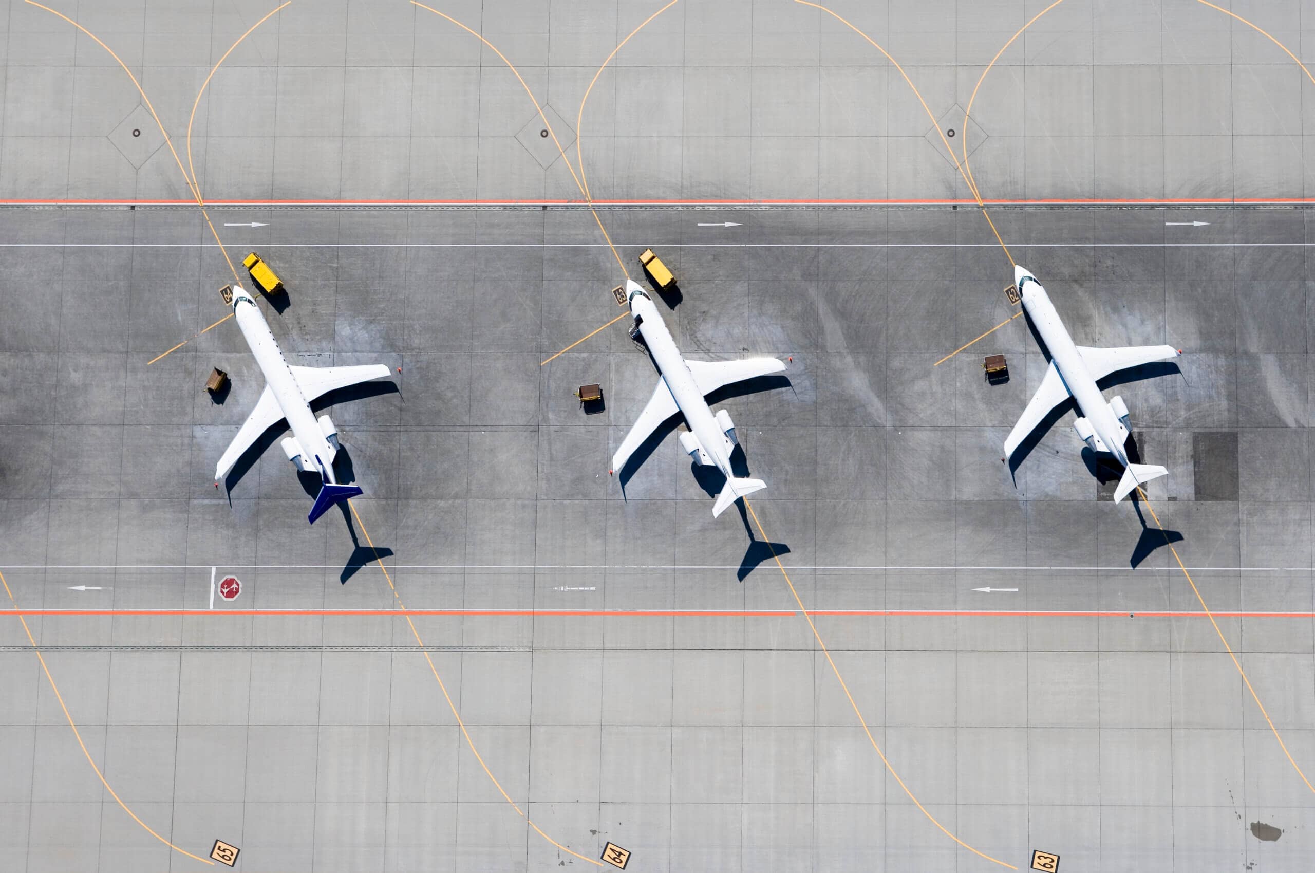 Aerial view of three airplanes in a row