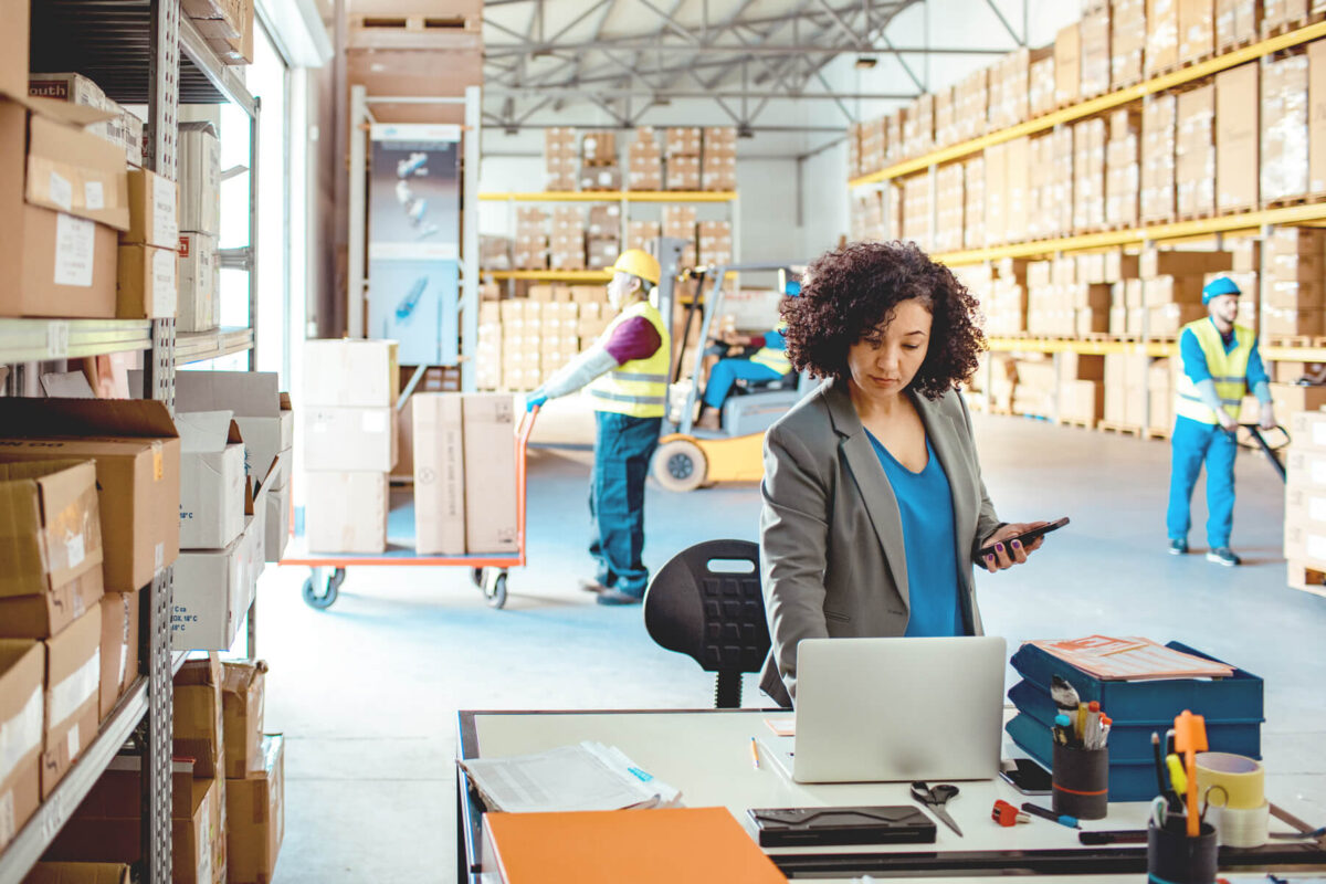 Warehouse Manager using a laptop