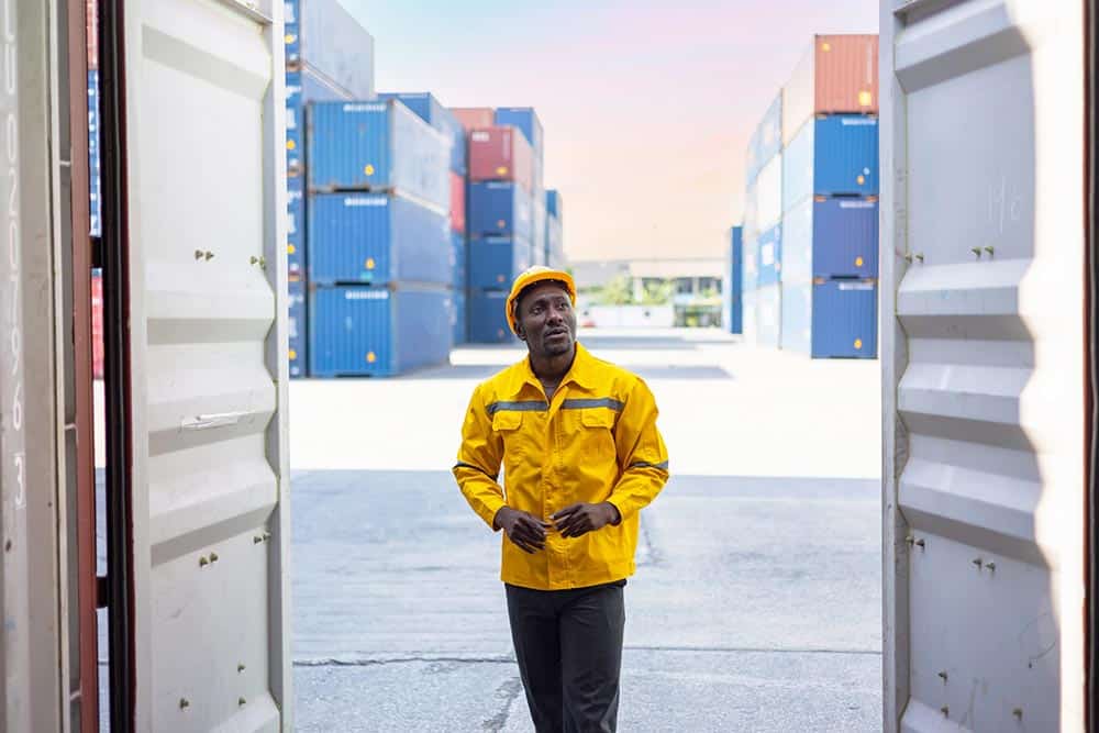 Commercial docks worker examining containers