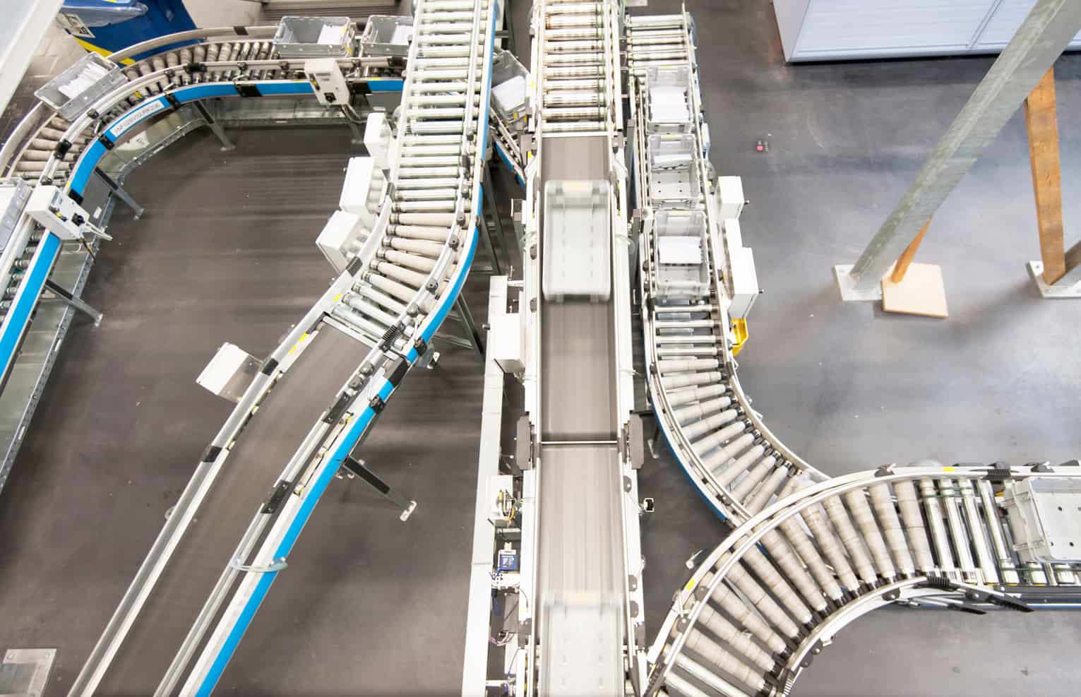 Containers for letters and mail items on a fully automatic conveyor belt in the central sortation section of the federal Swiss postal service in Zurich-Mulligen, Switzerland. On an area of 70'000 square meters, Swiss postal service is processing the majority of 15 million letters per day in Zurich-Mulligen, the largest of three mail sorting section hubs in Switzerland.