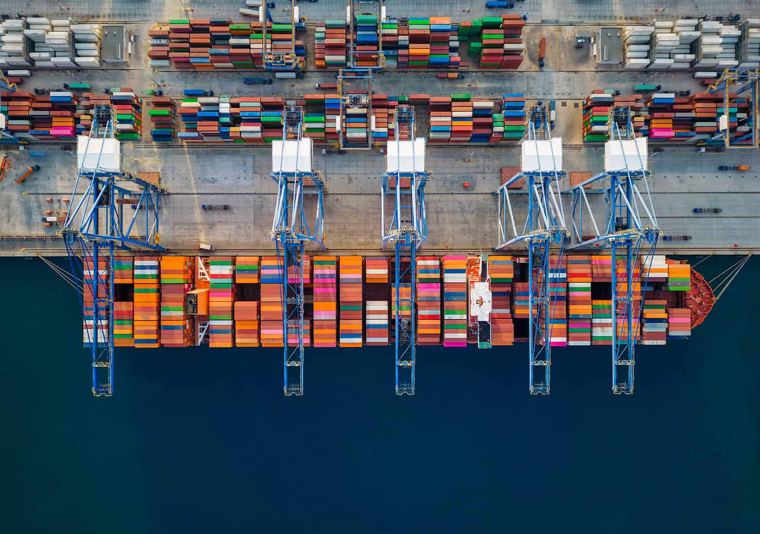 Aerial Top Down View Of A Large Container Cargo Ship Being Unloa