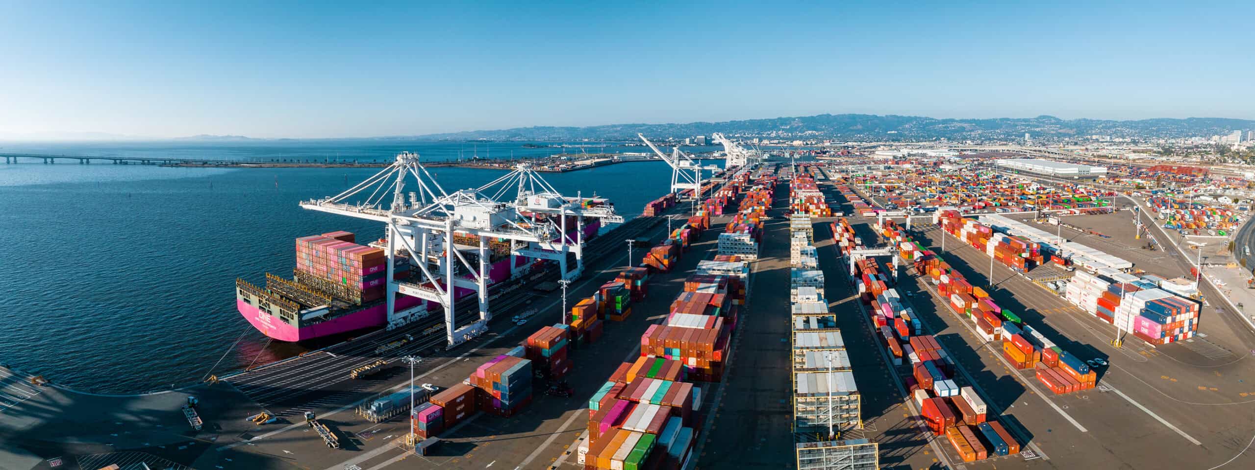The Oakland Outer Harbor Aerial View. Loaded Trucks Moving By Co