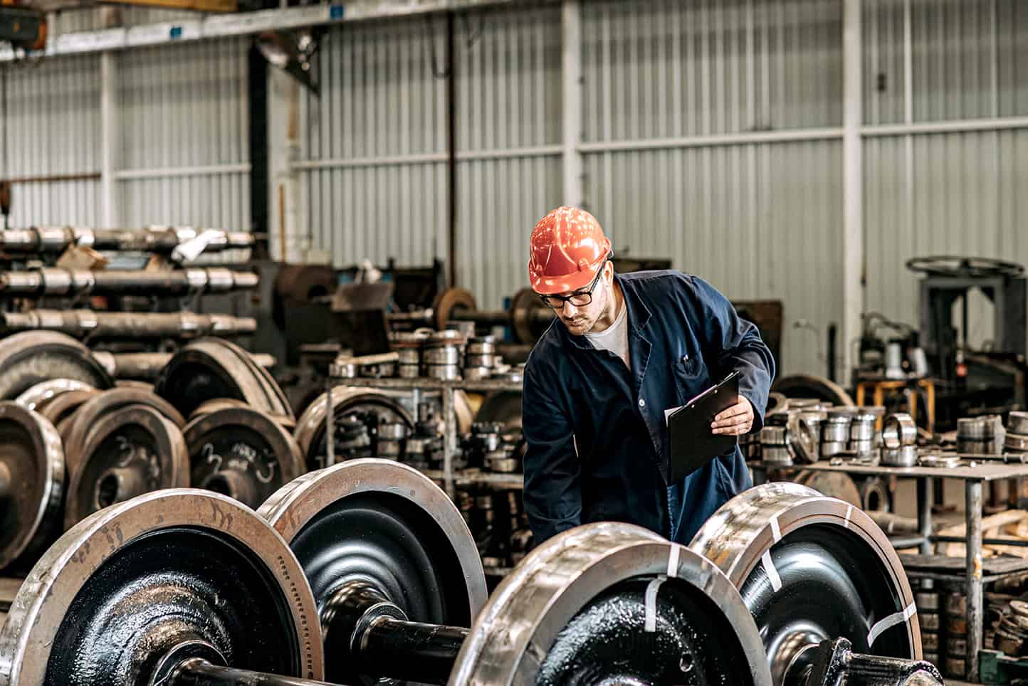 Man,working,at,train,factory,,quality,control,check.